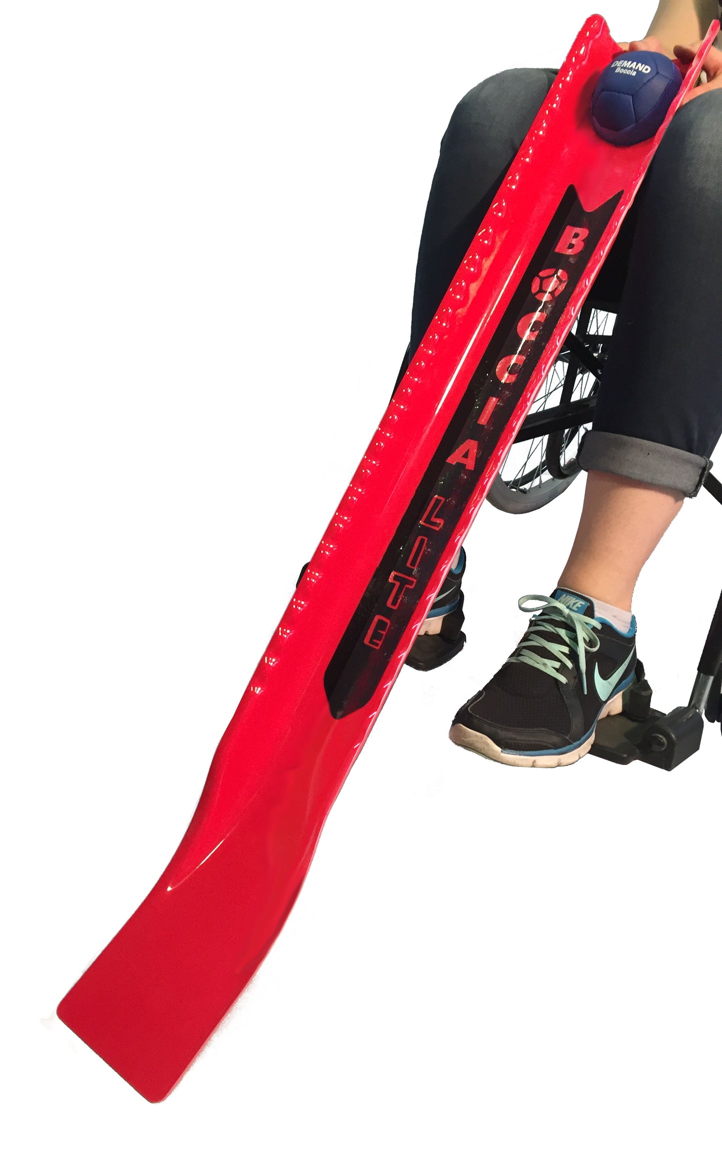 View of boccia lite ramp in red resting on a wheelchair user's knees with ball in ball rest