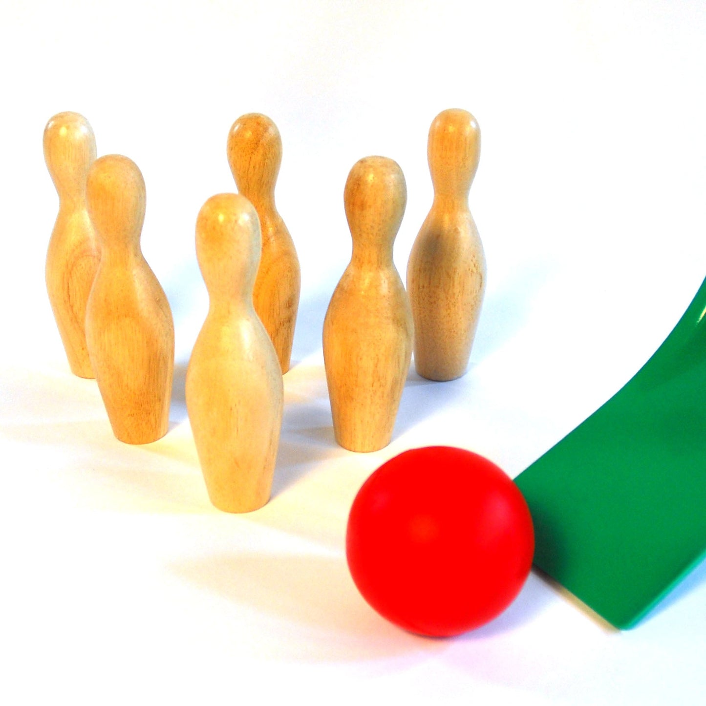 Close up view of two balls and 6 wooden skittles